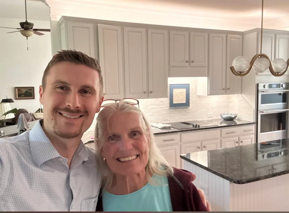 Preston with a smiling woman in a kitchen